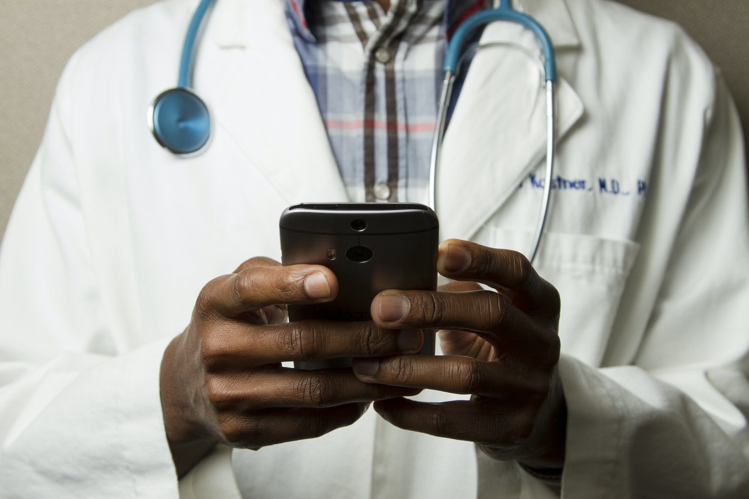 Doctor looking through a cell phone
