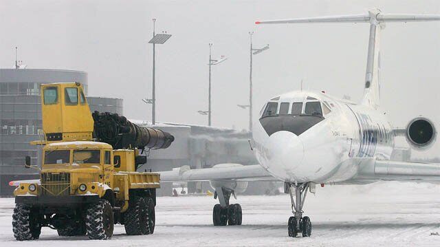Photo of a soviet jet engine being used to blow snow off a jet.