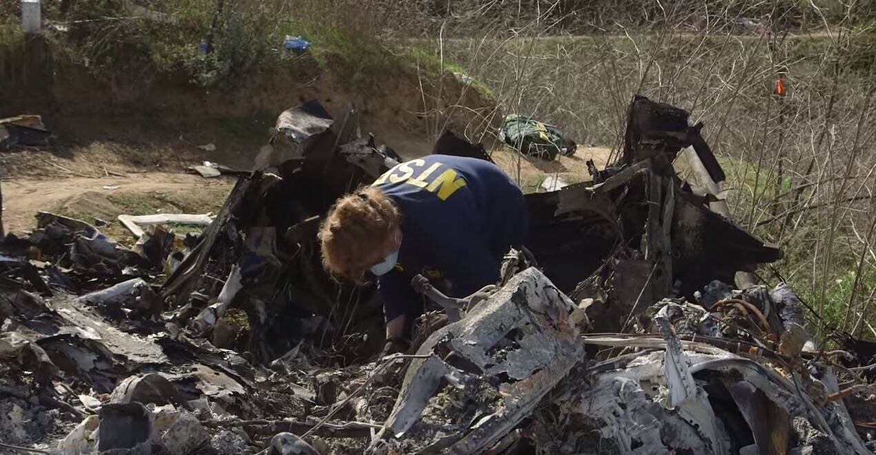Photo of an NTSB agent assessing damage of Kobe Bryant helicopter crash.
