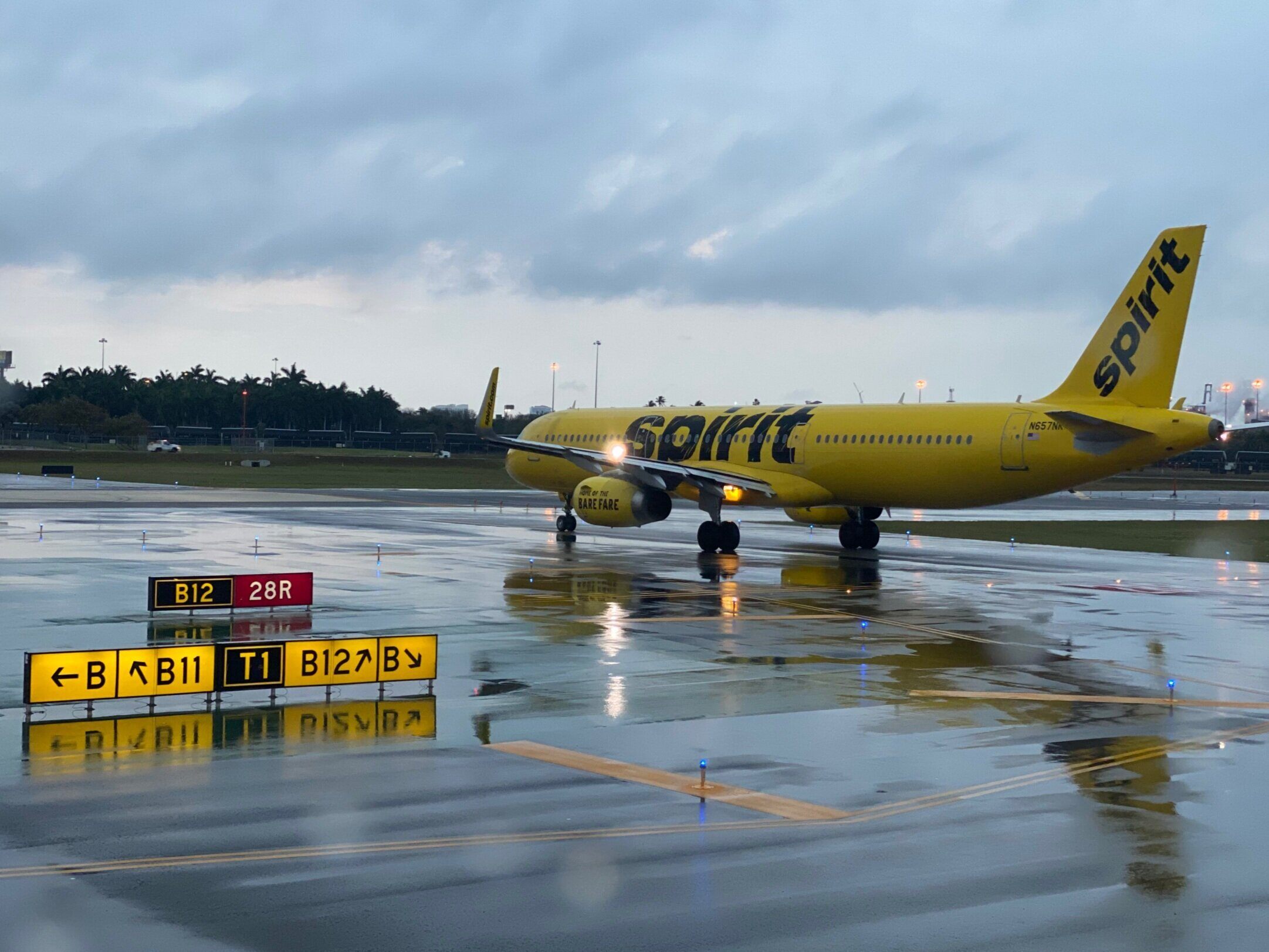 Image of a Spirit Airlines jet on a wet taxiway.